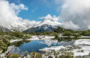 Southland: Small mountain lake with reflection, view of cloud-covered