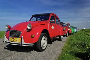 Auto: Small old cars along dike or levee, Holland