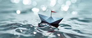 Sailing: Small paper ship on a glittering lake