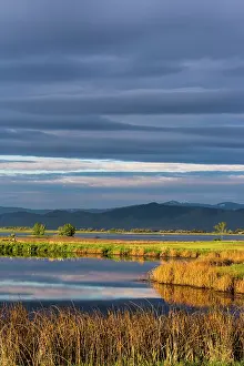 Mission: Small pond reflects the clouds at sunrise