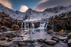 Skye: Small river with waterfall in snowy landscape with