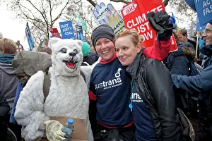 Demonstrating: Smiling Climate campaigners with man dressed as