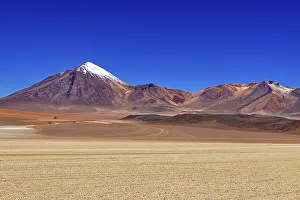Plateau: A snow-capped mountain rises in front of a vast