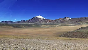 Abandoned: A snow-capped mountain rises above a vast