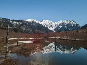 Honshu: Snow-covered Japanese Alps reflected in Lake Taisho