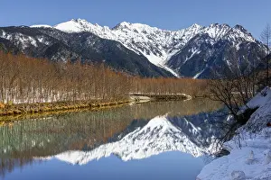 Honshu: Snow-covered mountains at a lake, Japanese Alps