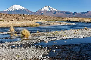 Volcanoes: Snow-covered volcanoes Pomerape and Parinacota with