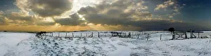 Sunburst: Snowy landscape under a sunburst sky