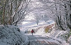 Anthony Harrison: Solitary female pedestrian walks through snow covered