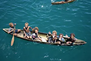 Canoes: Solomon Islands children in canoe
