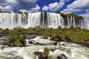 Waterfalls: A spectacular waterfall plunges down in the middle of a green and lush landscape