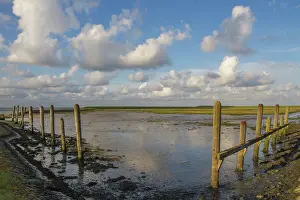 Beveland: Spring clouds over an old Dutch harbour at low tide
