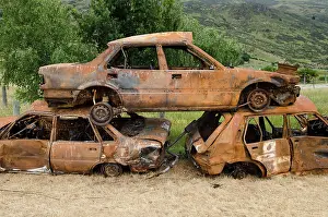 Wrecks: Stack of three rusty car wrecks, car cementery