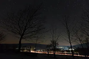 Trails: Starlit Sky - and car headlight trails - village in winter