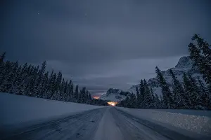 Roads: Starry sky during a winter road trip on the Icefields Parkway with lots of snow and ice