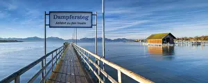 Home: Steamer jetty and boathouse on Lake Chiemsee in autumn in the morning light