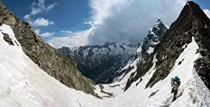Mountaineer: Steep snow field, Scharte, hiker on the descent