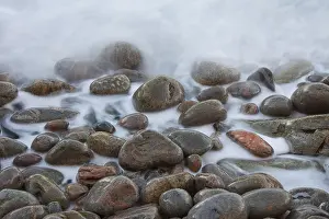 Shingle: Stones in the waves at coastline - Kullaberg - Skane, Sweden