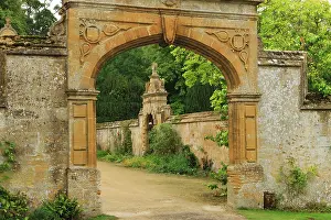 Features: Stonewall entrance to Stanway House, a castle in