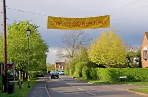 Demonstrating: 'Stop eco new townI banner across road