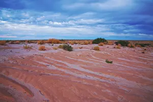 Eyre: Storm clouds over desert around Lake Eyre