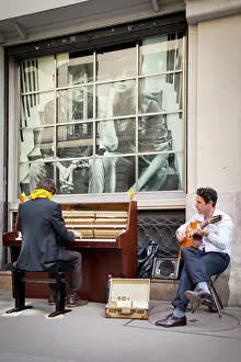 Piano: Two street buskers playing on a sidewalk