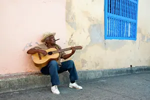 Guitar: Street musician playing guitar in the historic town