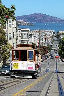 Tram: Street scene with a Cable Car tram and Alcatraz