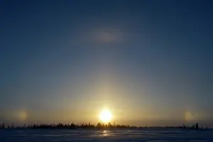 Warmth: Sun halo with three by suns on the tundra