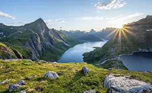 Reflex: Sun shining over mountain landscape with fjord Forsfjorden