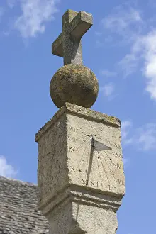 Crosses: Sundial on medieval cross in Cotswold village of Stanton