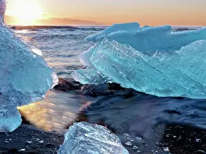 Environmentalism: Sunrise and iceberg formation on the beach