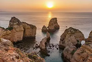 Reddish: Sunrise over the sea, rocky coast of sandstone