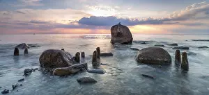 Groynes: Sunrise on the shore of the Baltic Sea
