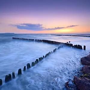 Groyne: Sunset at the beach of the Baltic Sea, crossing