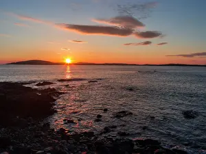 Archipelago: Sunset over the island of Papa Stour. Shetland