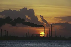 Stacks: Sunset behind Oil Refinery