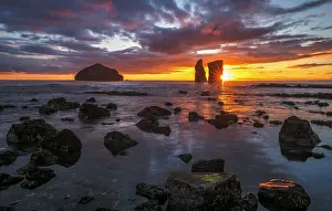 Azores: Sunset behind rock formation on the beach of Mosteiros