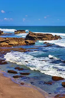 Wave: Sunset at rocky shoreline of Love Beach