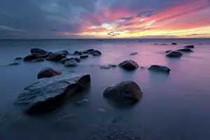 Xd6land: Sunset at sea with boulders in foreground