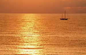 Yachts: Sunset - over sea with small boat