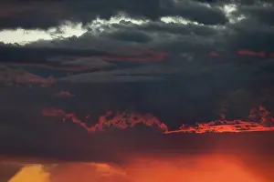 Utah: Sunset turns cumulus clouds bright red and orange