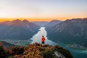 Rofan: Sunset, young man looking over mountain landscape