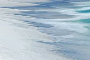 Galapagos: Surf pattern washing up on white sandy beach, Espanola
