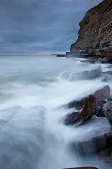 Breakers: Surf on the rocky coast with cliffs, Dunraven Bay