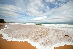 Bodies: Surf on the sandy beach of Bluff Beach on the island