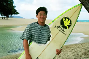 Attacks: Surfer after attack by Tiger Shark - holding board