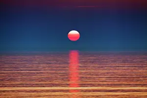 Smooth: Surreal sunset at the sea, smooth water surface