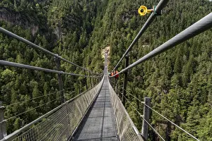 Bridge: Suspension bridge with safety camera over wooded gorge in the Sarntal Valley