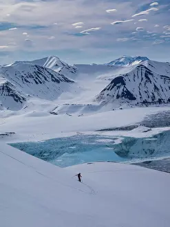 Powder: Svalbard, Norway. Guide and skier enjoys a pristine